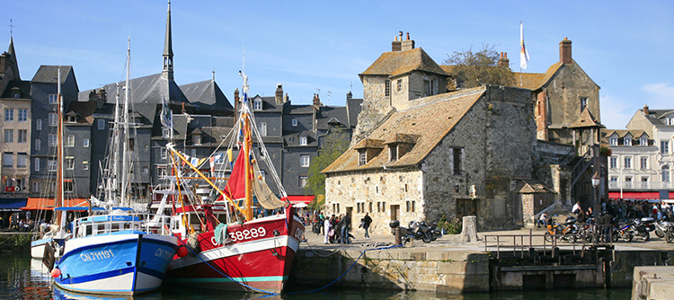 Fishing boats and old buildings in the port of Honfleur, France