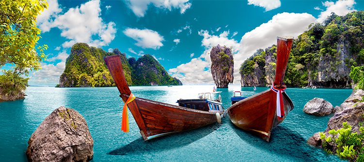 Traditional gondola boats ready to sail on the crystal blue waters of Phuket